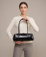 Aubrine Anouk Baguette Bag in Black, held