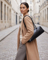 Aubrine Anouk Baguette Bag in Black, worn on the shoulder