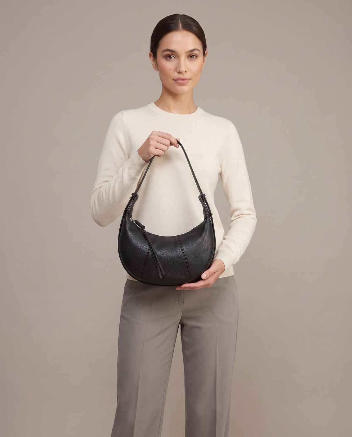 Aubrine Bernadette Crescent Bag in Black, held