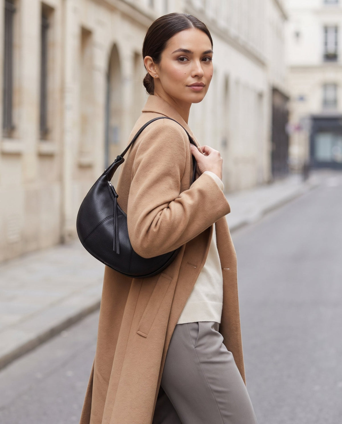 Aubrine Bernadette Crescent Bag in Black, worn on the shoulder