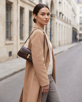 Aubrine Constance Baguette Bag in Black, worn on the shoulder