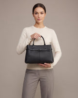 Aubrine Ernestine Satchel in Black, held